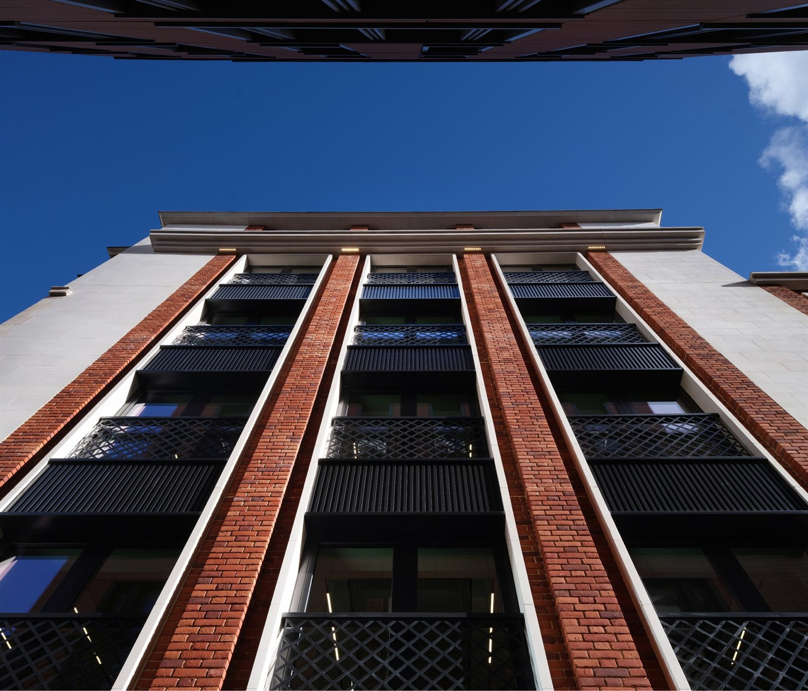 Brick and stone façade of Hanover Place viewed from below