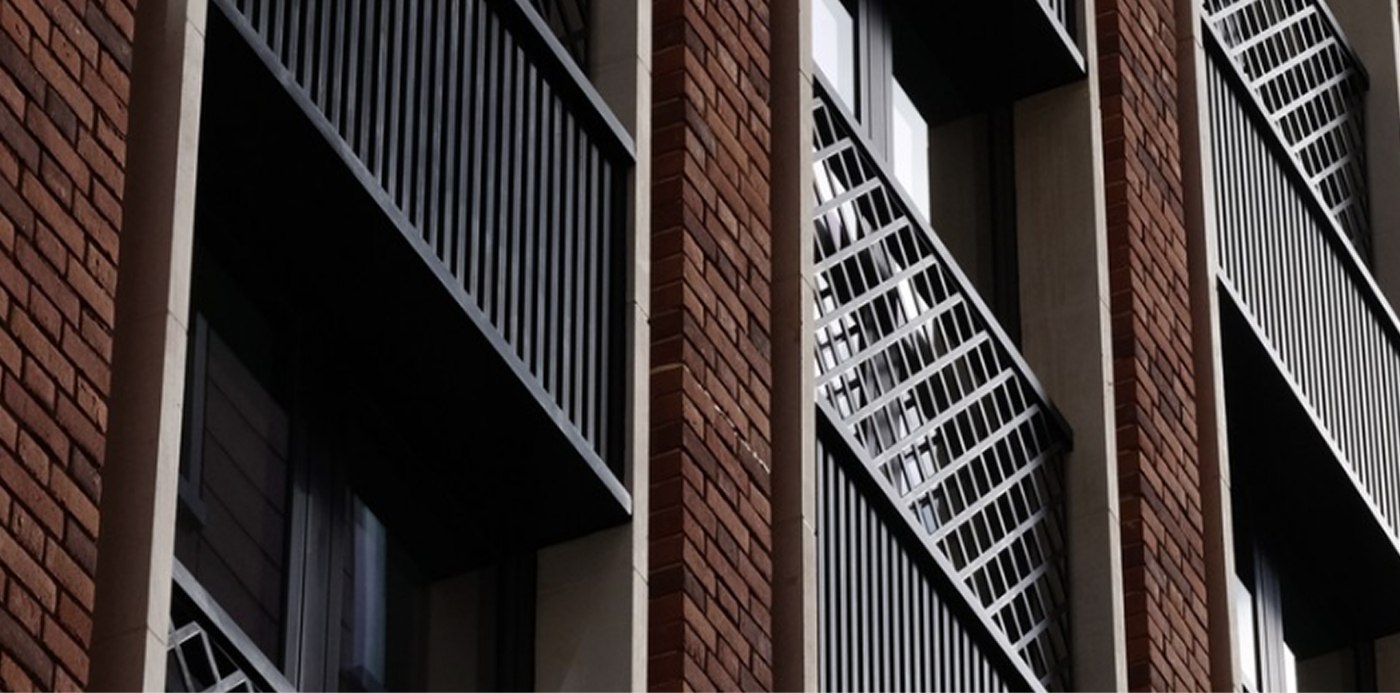 Brick façade and metal balcony screens at Hanover Place